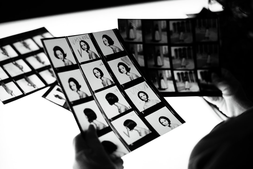 a person holding a bunch of pictures of people