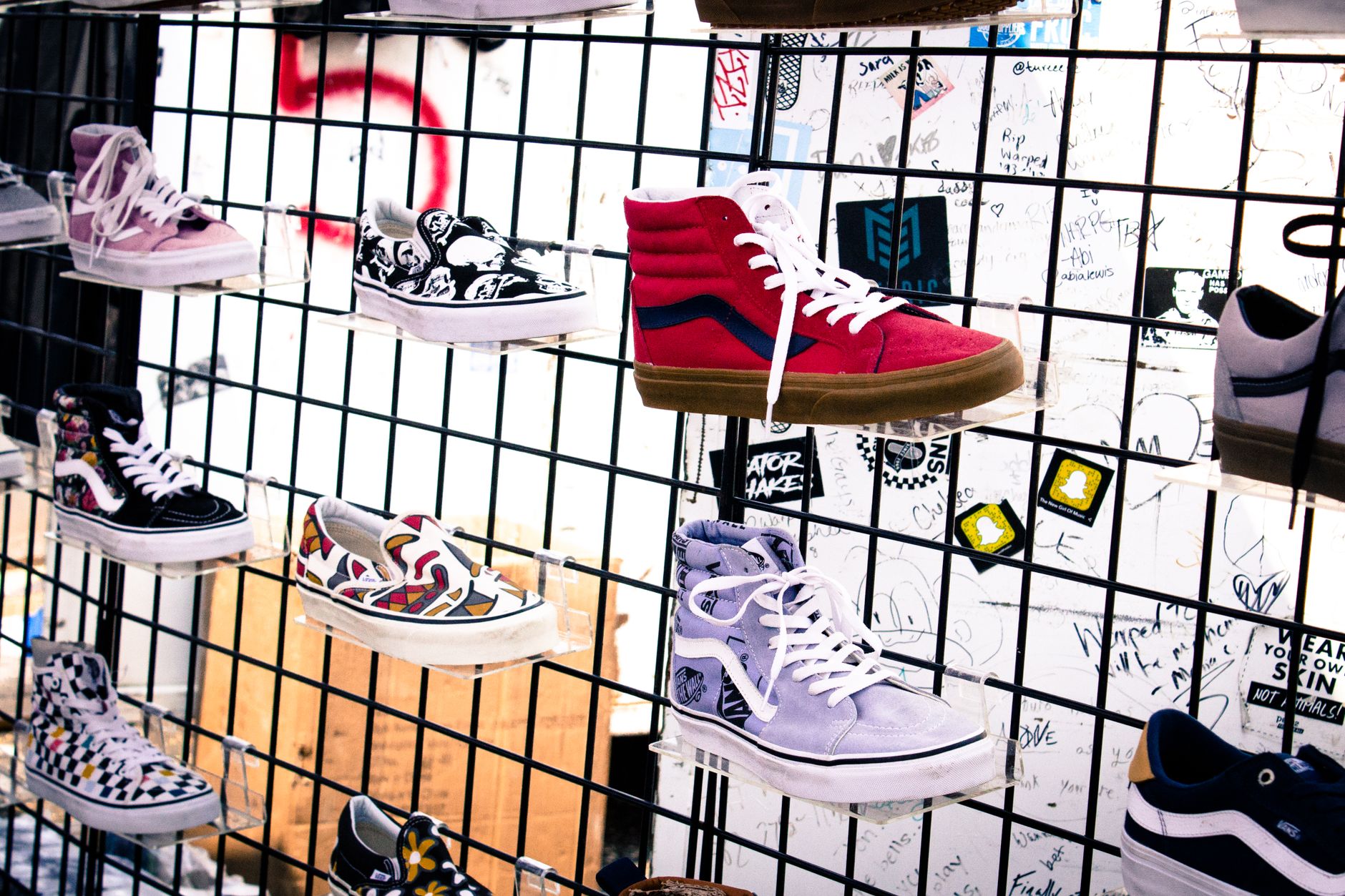 Colorful array of sneakers on display in a trendy urban store setting.