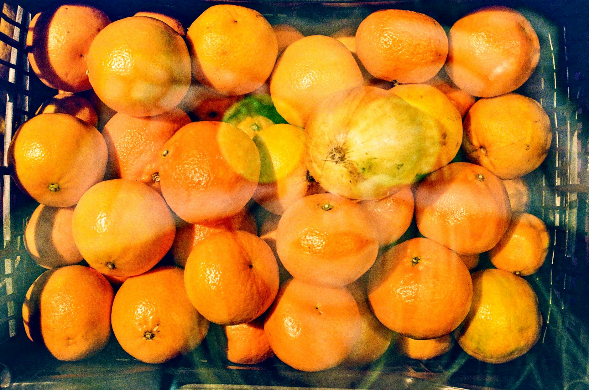 A colorful display of fresh oranges in a crate, perfect for citrus lovers.