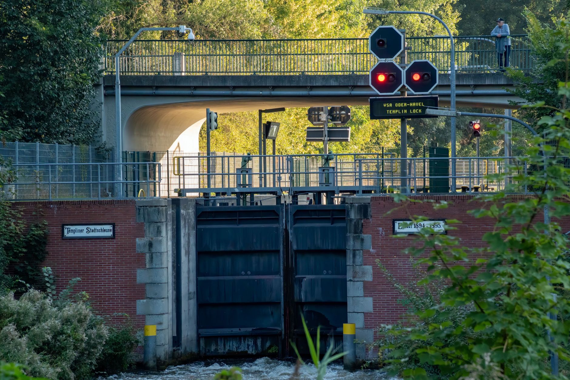 A detailed view of Templin Lock with a prominent traffic signal on a sunny day.