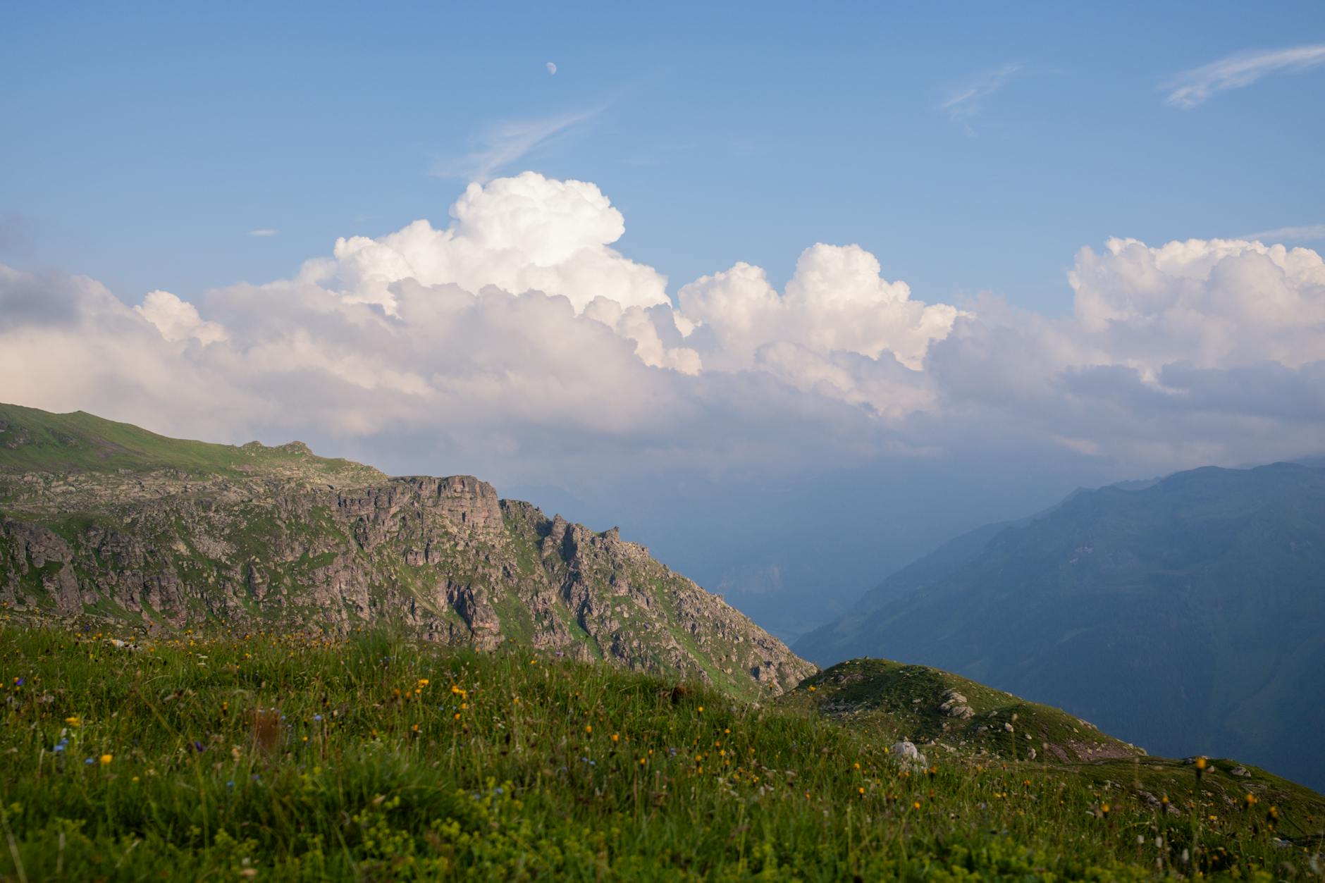Capture of the breathtaking Glarus Alps with lush meadows and dramatic clouds, perfect for nature lovers.