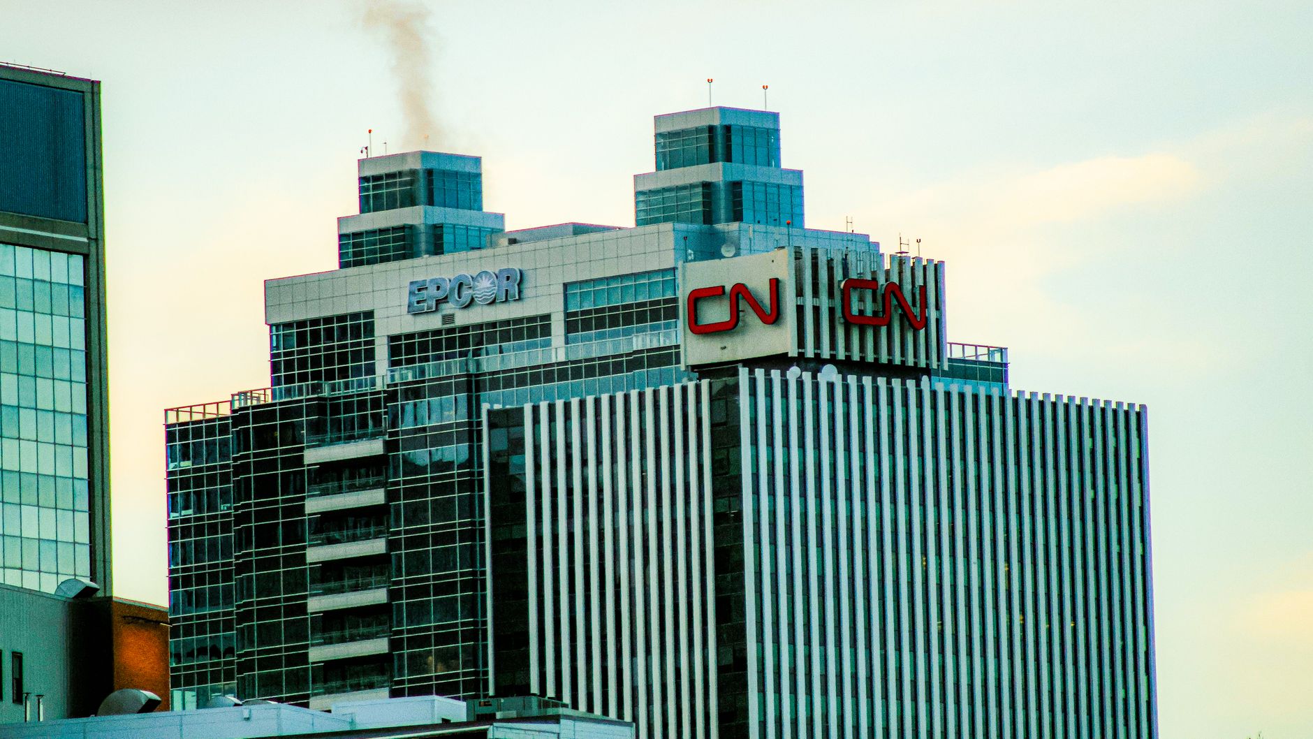A view of skyscrapers with CN and EPCOR logos against a clear sky.