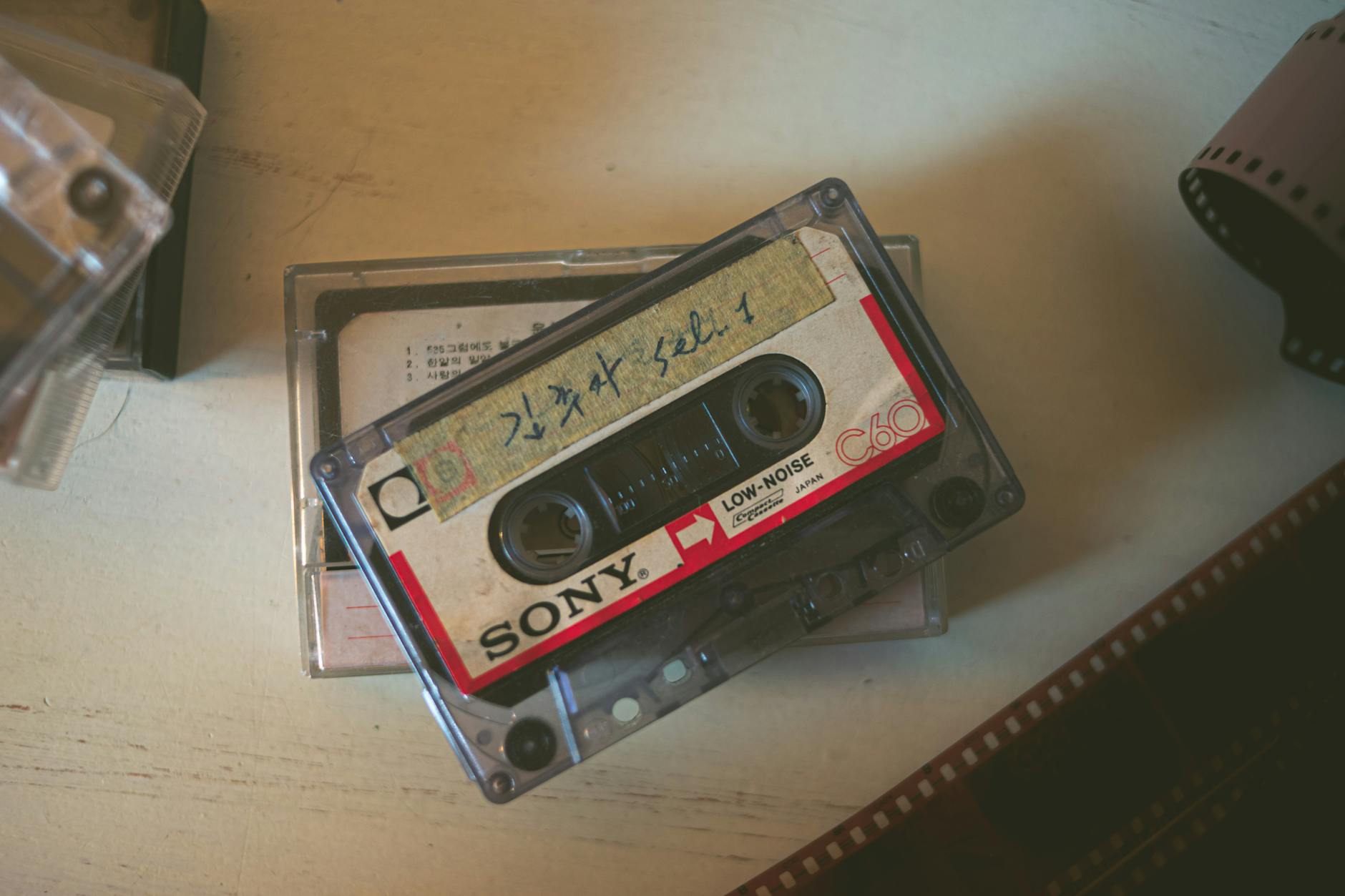 Close-up of a vintage Sony cassette tape on a wooden surface, evoking nostalgia.