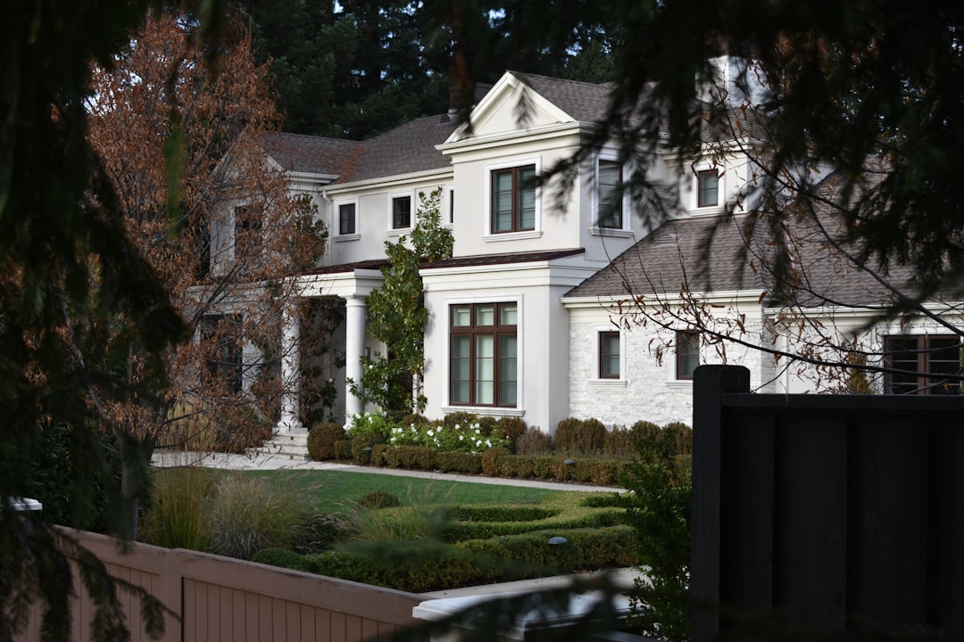 a large white house with a garden in front of it