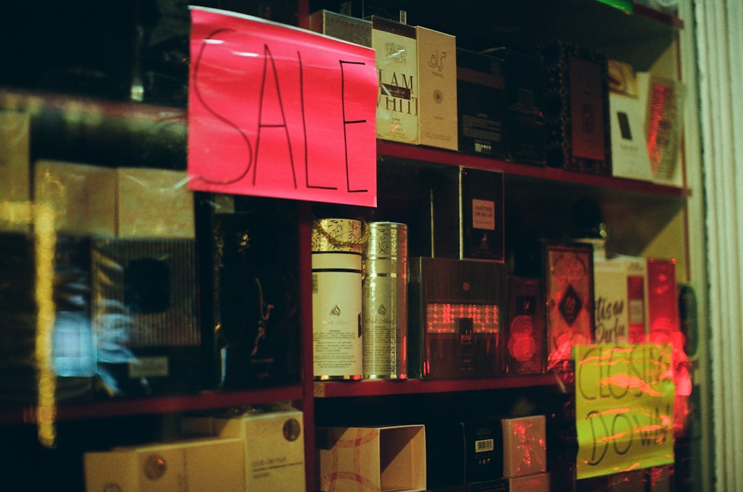 Shelves of perfume bottles with sale signs.